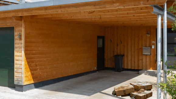 A photo showing wet cardboard boxes sitting underneath the carport outside a home with the words "general pest tips" on the image.